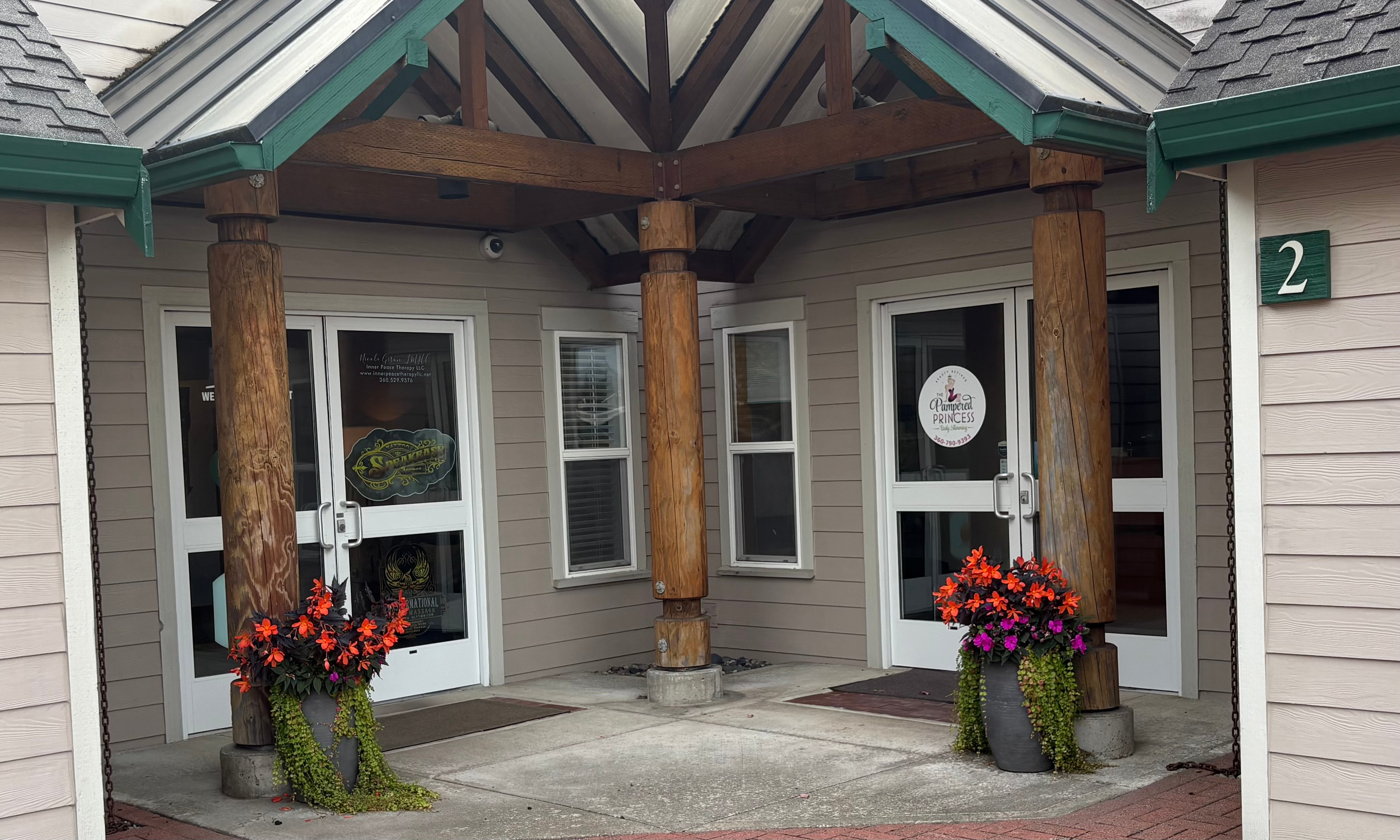 EdenSpa Wellness office exterior — covered entrance with wooden columns